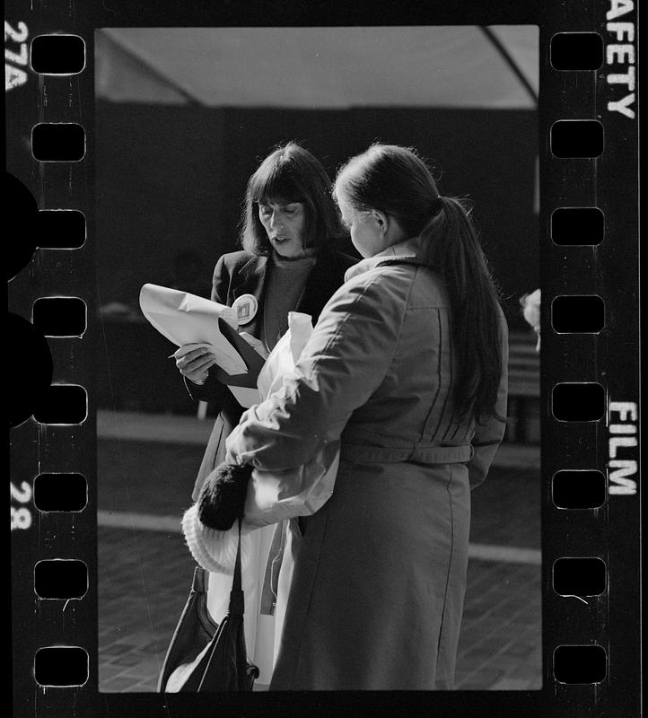 Market researcher interviews customers at shopping mall in Brighton