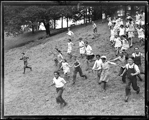 Children outside, running down a hill