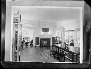 Room with table, fireplace, and plaque