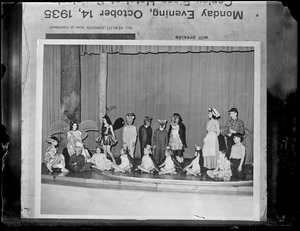 Children in costumes and masks on stage