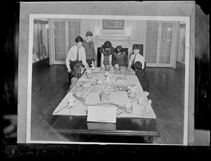 Children gathered around a model of a town