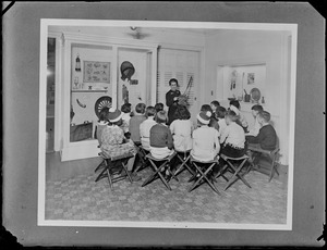Children gather around an exhibit for a lecture