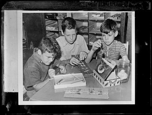 Boys mounting butterfly specimens