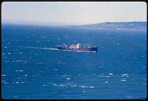 Boat reading "Great Eastern" on water with hills on horizon, likely California