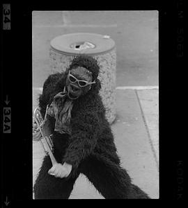 Person in ape costume with trumpet