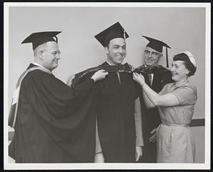 Dress Rehearsel -- Wayne L. Oak, second left, of Randolph, practices for Northeastern University Commencement exercise, June 16, by letting his wife, Myrna, and Dean Gurth I. Abercrombie, director of the Graduate Division in the School of Business, try on his Master's degree hood. Dean Albert E. Everett of the School of Business looks on.