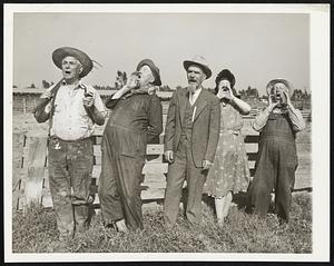 Sooey! Sooey! Long Beach, Calif.- Plain and fancy ways of rendering a "sooey", calculated to make any hog leave his rooting and come on the run, are demonstrated by these five competitors in the national hog calling contest to be held here sept. 13 in connection with the all states picnic. From left to right: Frank Heyden of Kansas gives the call that follows a puff on the pipe; Joe Turner of Indiana uses a one-handed megaphone technique and leans backward to get more volume; Jack Dalton of Oklahoma demonstrates the call that made him last year's national champion; Mrs. Nellie Collister, Michigan Champion, uses the two-handed megaphone call; and Edward Rill of Kansas goes in for an oversized double-handed megaphone style.