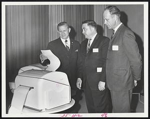 Computer Facility dedication in Cambridge yesterday found Gov. John A. Volpe, left, examining a Univac computer while Commerce Commr. Theodore W. Schulenberg, right, looked on. In the center is Charles W. Adams, president of Adams Associates, whose division, Keydata Corporation, operates this new "computer utility."