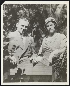 Earl Sande and His New Bride on Honeymoon Earl Sande, Premier Jockey, Photographed at Miami Beach, Fla., Recently With His bride, The Widow of Clarence Kummer, Also a Jockey and One of Sande's Best Friends. They Were Married Recently in New York and Now are the Guests of the Bride's Parents, Mr. and Mrs. Alfred Gasdoyne of Jamaica.