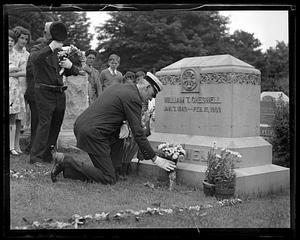 Unidentified man laying flowers at the grave of William T. Cheswell, Boston Fire Department Chief