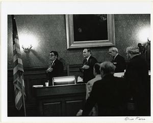 Cambridge City Council, the Pledge of Allegiance, (left to right) Secretary to the Mayor Paul Morris, City Clerk Paul Healy, and Mayor Alfred Vellucci, 1970