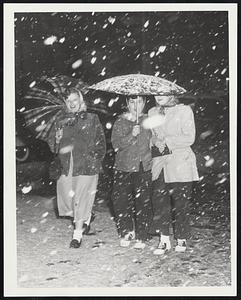 April Showers of the sort that fell last night were not at all the “will bring May flowers” type. Shirley Lindquist, Pat Gaetano and Jane Stack (left to right), all of Malden, stroll through the snow on Boston Common.