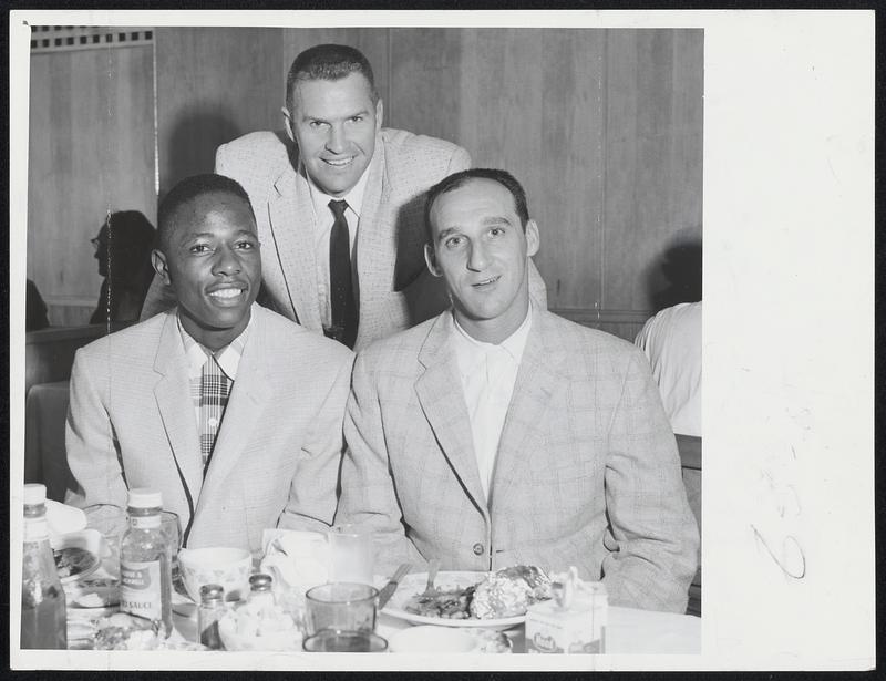 Back "Home" for first time since 1952, three Braves players enjoy leisurely dinner before exhibiting game with Red Sox at Fenway Park. Left to right, Hank Aaron, Del Crandall and Warren Spahn.