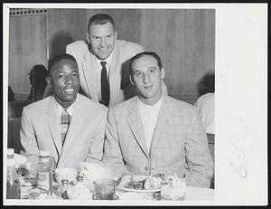 Back "Home" for first time since 1952, three Braves players enjoy leisurely dinner before exhibiting game with Red Sox at Fenway Park. Left to right, Hank Aaron, Del Crandall and Warren Spahn.