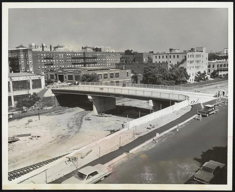 To Ease Traffic -- This new bridge for St. Mary street at the Boston-Brooklyn line, over the extension of the Massachussetts Turnpike, was opened to traffic yesterday. The &150,000 structure will be part of a detour during the reconstruction of the Commonwealth Avenue Bridge at the Boston University Bridge. The three spans total 170 ft. The roadway, with two sidewalks, is one foot wider than the old bridge.