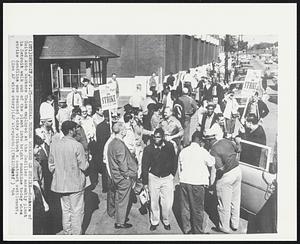 Detroit – General Motors Workers On Strike – Members of United Auto Workers Union employed at the Cadillac assembly plant in Detroit walk out of the plant into bright sunshine today when strike deadline was reached today without a contract settlement.