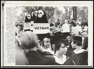 Protest at Commencement -- Four graduating Wilson College girl students in Chambersburg, Pa. wear protest costumes at end of commencement procession. Mrs. Mamie Eisenhower, an honorary degree recipient, refused to receive her degree unless the costumes were removed. Before the ceremony started, the rains came ruining the costumes and ceremony went indoors. Mrs. Eisenhower received her degree.