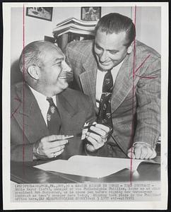 Sawyer Signed to Three - Year Contract - Eddie Sayer (left), manager of the Philadelphia Phillies, looks up at club president Bob Carpenter, as he opens pen before signing new three-year contract as team's manager here today. Signing took place in the Phillies' office here.