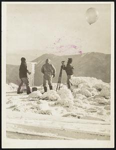 Trial Balloon. Meteorologists atop Mount Washington, in New Hampshire, sending up a balloon to see how the weather is way up there. It's plenty cold on the peak where they stand, but it's even colder father up, according to instrument attached to the balloons.