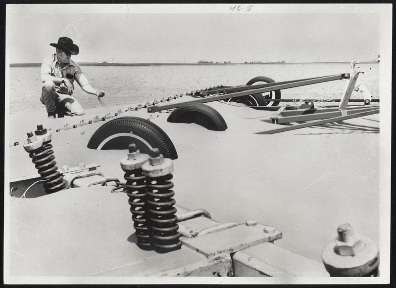 A Scene From The 1930's? Farm equipment lies nearly buried on a field near Tipton in southwestern Oklahoma this year. Farmer Keith Pinson lets the dust run through his fingers as many residents of the area, recalling similar scenes of the 1930's, wonder what may be in store for them should the current dry spell continue.