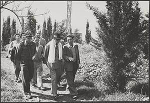 Serge Koussevitzky walking with an unidentified group of people