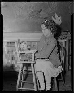 Girl playing with doll, possibly Children's Hospital