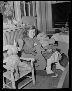 Girl playing with teddy bear, possibly Children's Hospital