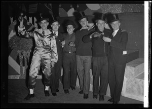 Performers posing on stage set