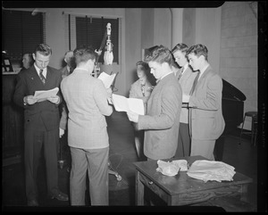 Group of men around radio microphone