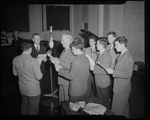 Group of men around radio microphone