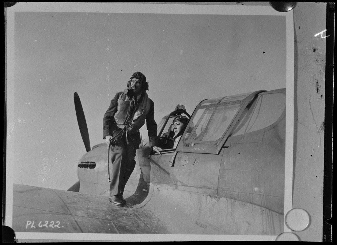 Two unidentified men, one of them possibly Steve Day, with plane