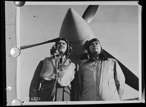 Two unidentified men, one of them possibly Steve Day, with plane