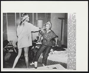 Beverly Aadland Apartment Scuffle--Beverly Aadland, 17-year-old former sweetheart of Errol Flynn, and her 53-year-old mother, Mrs. Florence Aadland, scuffle in the Aadland Hollywood apartment three weeks ago in this picture taken by a friend of the girl's, Bob Profeta. Profeta said the picture shows Beverly dropping her mother to the bed with two right jabs. He said an argument had begun over a loud television set.