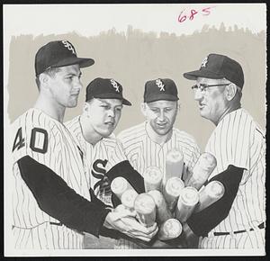 Chicago Manager Al Lopez hands over a load of bats to new players at White Sox spring training camp in Sarasota, Fla. Left to right, the players are Mike Hershberger, Bob Farley and Joe Cunningham. They were acquired by the Chisox in trade for Minnie Minoso, Billy Pierce, Don Larsen and Roy Sievers during the winter.