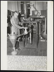 May Revolutionize Milling -- W.W. Niven, of Midwest Research Institute here, operates experimental plant which mills wheat without rollers and by use of cepressed air, a method which institute heads say may revolutionize milling industry. Grain in cylinder A is fed by drive at B into chamber at C with a stream of compressed air from D. Air fills individual cells within grain, which shoots through nozzle within pipe at C and explodes. Shattered grain streams past valve under Niven's hand and into conical separator E, where it is removed from air stream, then emerges at F. Institute heads say it is possible to completely separate all component parts of grain, germ, husk, bran and flour, by process.