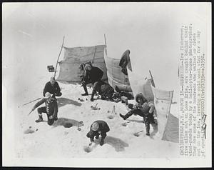 Surprise -- Ice fishermen, five miles out on lake Erie, are caught behind their wind-guards today by a helicopter-borne photographer. They are some of the hundreds who walked or drove out on the ice, braving a cold west wind for a day of sport.