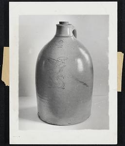 Come Fill the Cup-- A two gallon stoneware jug incised in blue with an eagle and swan. Stoneware such as this was the pride of the early 19th century New England pottery.