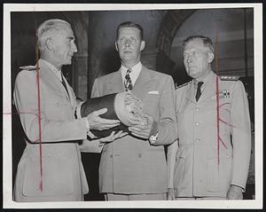 Battle Flag of USS Massachusetts is presented to Gov. Tobin, center, in the Hall of Flags at the State House by Rear Admr. Morton L. Deyo, left, commandant of the First Naval District. Rear Admr. W. D. Baker, commandant of the Boston Navy Yard, is at right.