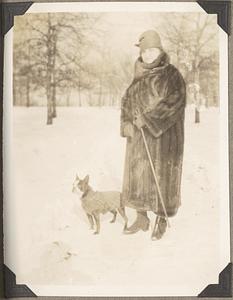 Natalie Koussevitzky in a fur coat holds the leash of a Boston terrier