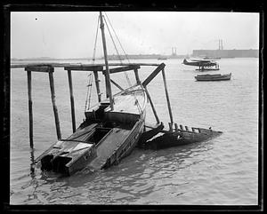 Byrd's plane at anchor in distance. Wrecked fisherman in foreground