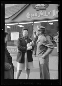 People stand outside of a Chock Full o' Nuts coffee shop