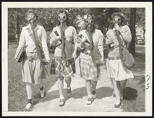 Campus Fashion Note-At the University of Detroit, co-eds are trying out gas masks in the possibility that they may become a necessary part of campus clothing. Behind the masks, from the left, are: Mary Turner, Helen Williams, Evelyn Buss and Joan Joliet.