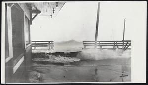 Below, huge waves caused by big blow rip the boardwalk apart at Carolina Beach, N. C.