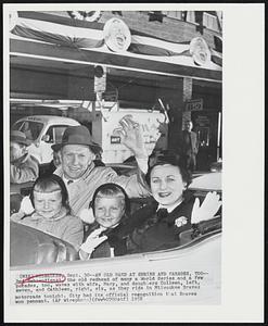 An Old Hand at Series and Parades, Too -- Red Schoendienst, the old redhead of many a World Series and a few parades, too, waves with wife, Mary, and daughters Colleen, left, seven, and Cathleen, right, six, as they ride in Milwaukee Braves motorcade tonight. City had its official recognition that Braves won pennant.