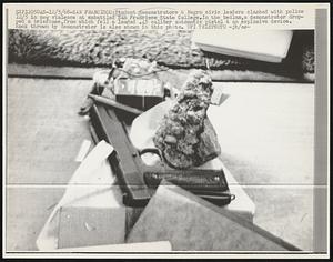 Student demonstrators & Negro civic leaders clashed with police 12/5 in new violence at embattled San Francisco State College. In the bedlam, a demonstrator dropped a briefcase, from which fell a leaded .45 caliber automatic pistol & an explosive device. Rock thrown by demonstrator is also shown in this photo.
