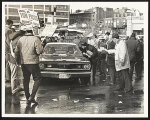 Teamsters Union member stop cars of members and encourage them to vote for their favorite candidate.