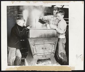 Boiling Down maple sap as they make syrup are young Claremont, New Hampshire boys from left, Richard Skillen, 10; John Hayward, 13 and Brian Dagenais, 10. The lads trudge through deep snow after school and collect the sap. They spend weekends boiling it down.