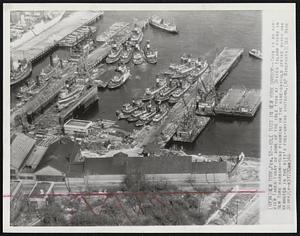 New York -- Idle Tugs in New York Harbor -- This is an air view taken today of some of the idle tugs at Staten Island piers in New York harbor -- Tugs figuring in the nine-day-old strike which has resulted in the city's fuel-saving shutdown.