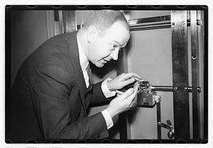 A man demonstrating how to break into a safe