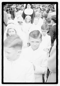 A group of children coming out of a church after their first Communion